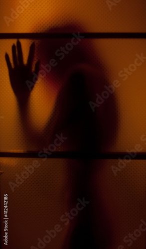 the dark silhouette of a girl in the doorway