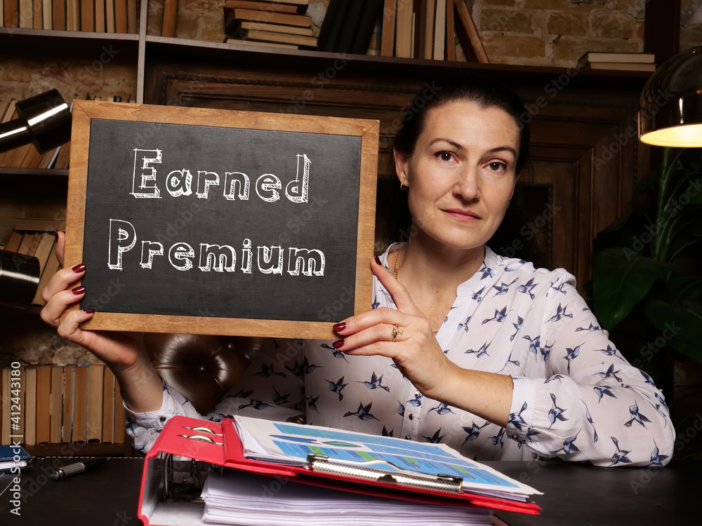Fototapeta premium Financial concept meaning Earned Premium with sign on black chalkboard.