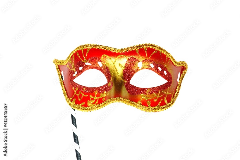 Red mask party or carnival Venetian mask with handle isolated on white background	