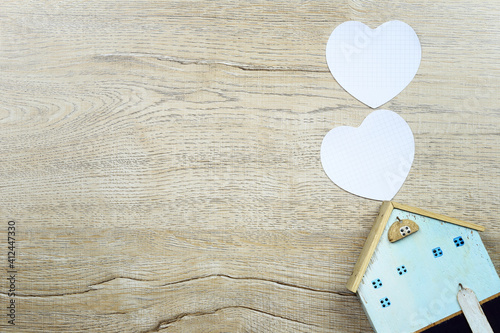 Paper heart shape and wooden house and have copy space.