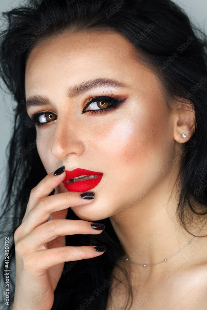 Beautiful young brunette model with bright make-up and long hair