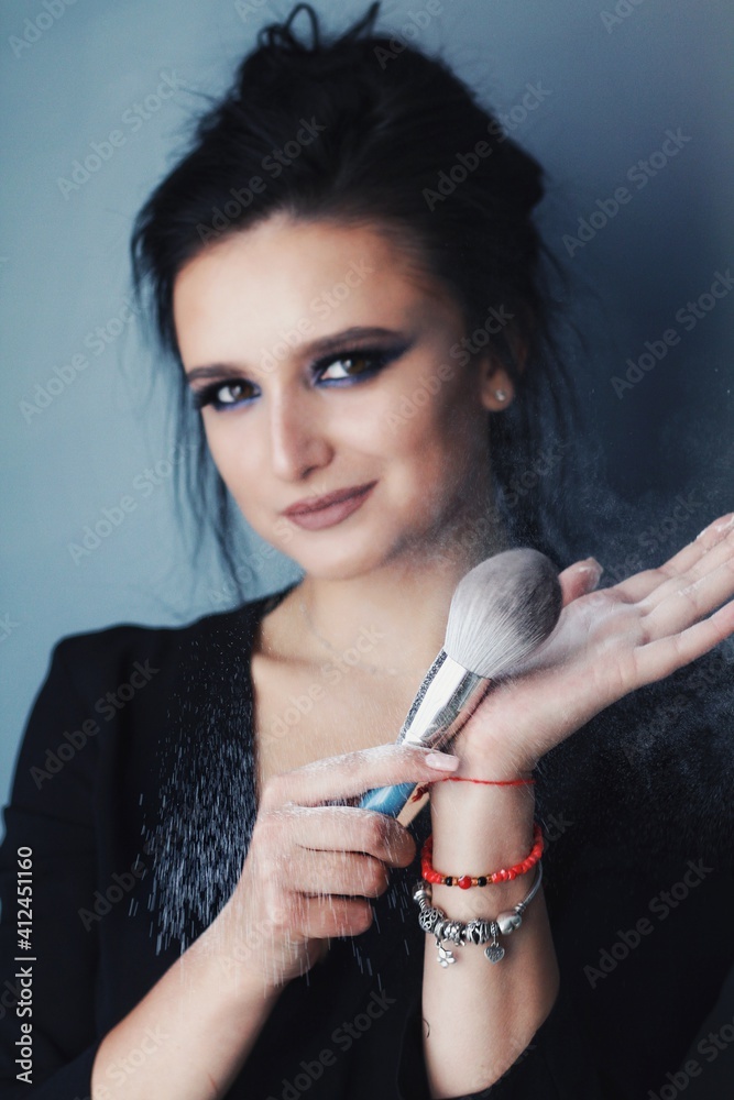 Beautiful young brunette model with bright make-up and long hair