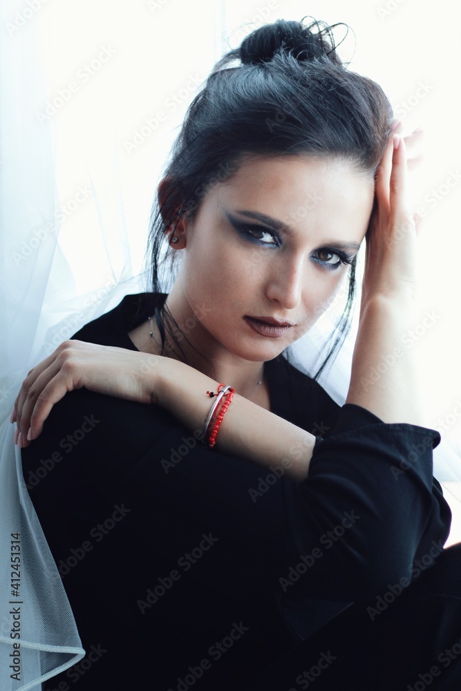 Beautiful young brunette model with bright make-up and long hair