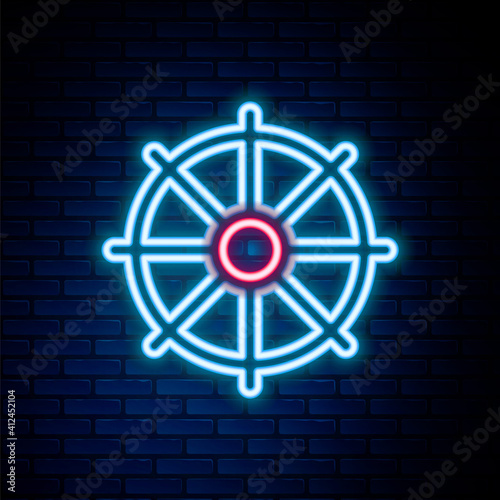 Glowing neon line Dharma wheel icon isolated on brick wall background. Buddhism religion sign. Dharmachakra symbol. Colorful outline concept. Vector.