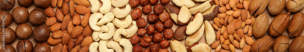 Set of different nuts on whole background, top view - obrazy, fototapety, plakaty 