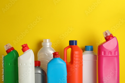 Blank bottles with different detergent on yellow background