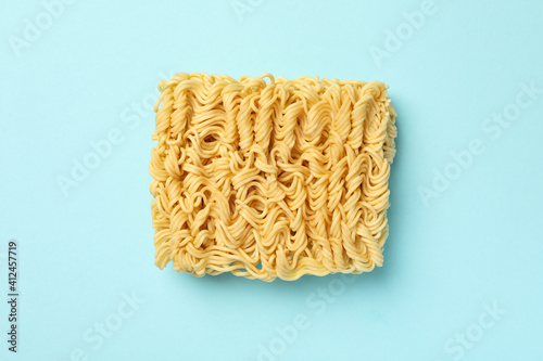 Piece of instant noodles on blue background