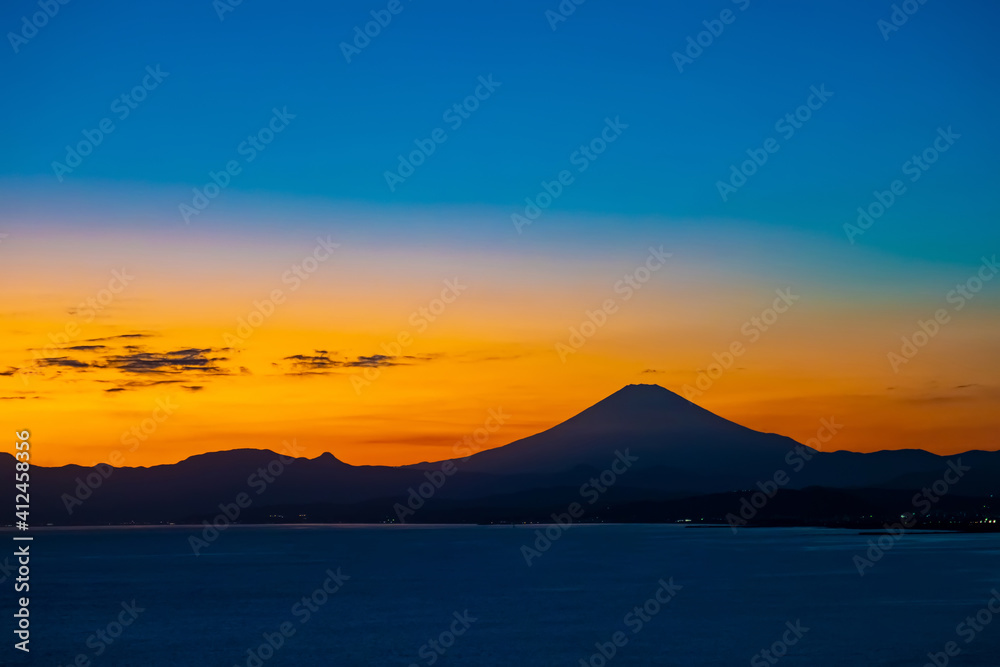 Japan. The sunset in Kawaguchiko. Fuji was silhouetted against the night sky. View of Fuji from the shore of lake Kawaguchiko. Japan at night. Natural attractions of Japan. Two-tone sky at sunset.