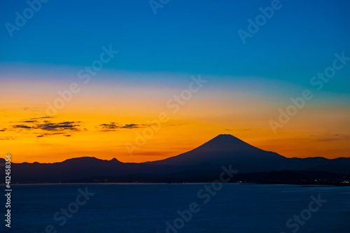 Japan. The sunset in Kawaguchiko. Fuji was silhouetted against the night sky. View of Fuji from the shore of lake Kawaguchiko. Japan at night. Natural attractions of Japan. Two-tone sky at sunset.