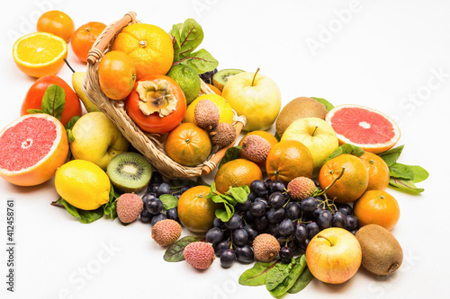 Set of varied  multicolored exotic fruits. Mandarins  grapefruit  lychee  kiwi and grapes with chard leaves