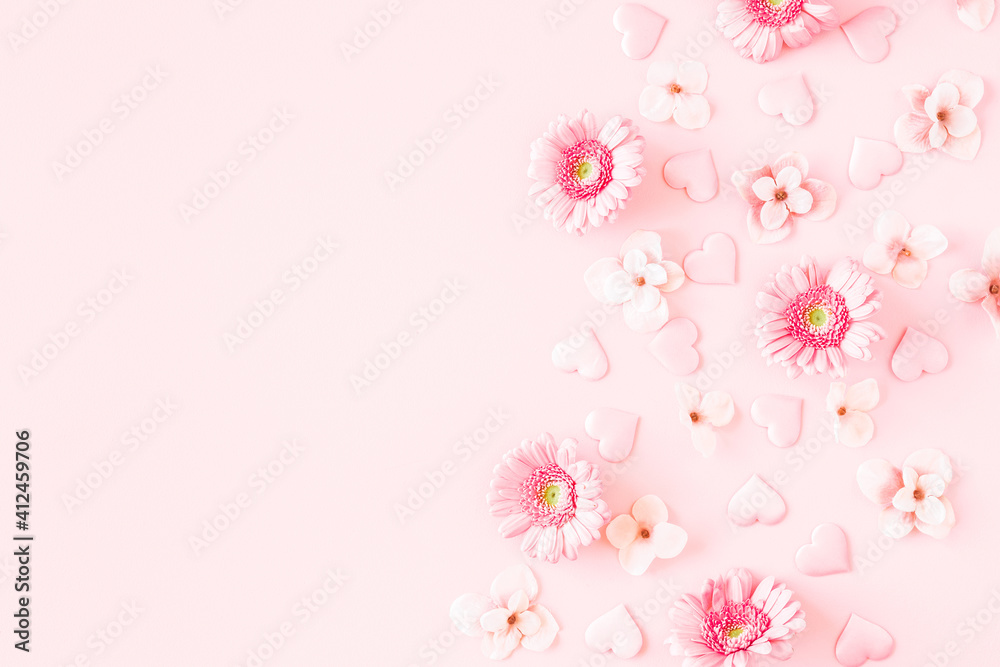 Valentine's Day background. Pink flowers, hearts on pastel pink background. Valentines day concept. Flat lay, top view, copy space