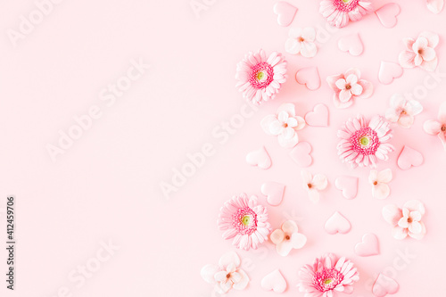 Fototapeta Naklejka Na Ścianę i Meble -  Valentine's Day background. Pink flowers, hearts on pastel pink background. Valentines day concept. Flat lay, top view, copy space