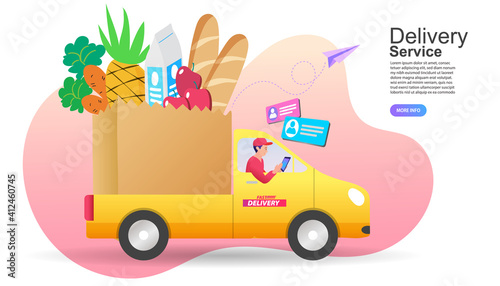 Delivery man driving yellow truck filled with fresh grocery food using mobile app. Concept of online supermarket shopping service, fast food logistics, and digital order tracking convenience.