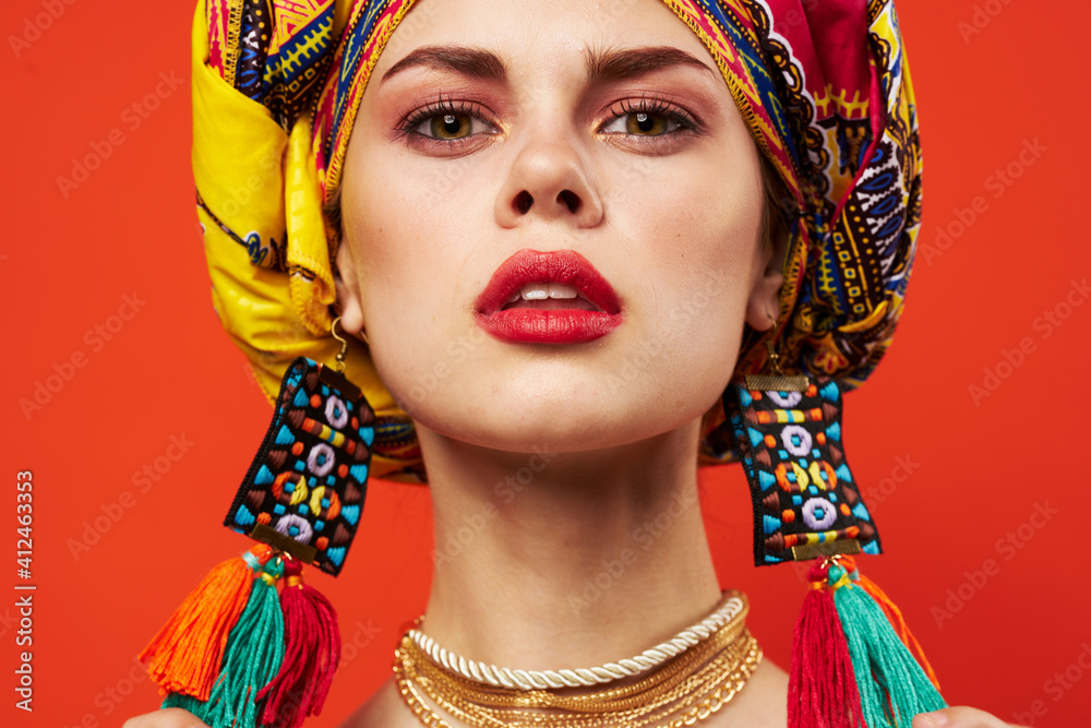 woman wearing multicolored turban decoration attractive look ethnicity red background
