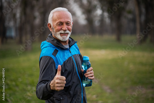 Happy senior man is ready for exercising in park.