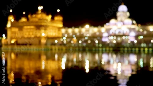 Amritsar, Punjab, India - January 06, 2019 : golden temple with reflection in the water at night photo