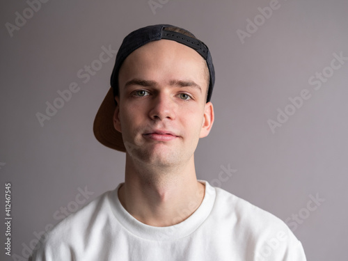 portrait of a handsome young man, a teenager in a cap