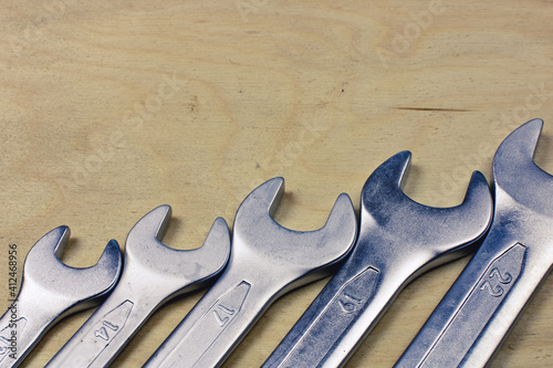 Set of wrenches and spanners keys lie in a row. A set of metric spanners or wrenches, open at one end.