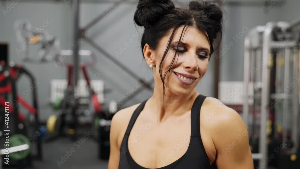 Beautiful woman posing in the gym. She shows her amazing body in different positions. Athlete portrait Beautiful woman posing in the gym. She shows her amazing body in different positions. Athlete portrait