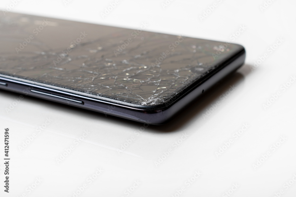 Macro shot of a smartphone with a broken screen. Selective focus. Macro shot of a smartphone with a broken screen. Selective focus.