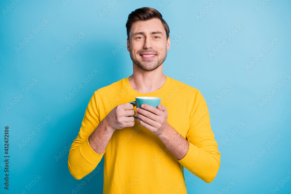 Portrait of attractive cheerful guy wearing casual drinking latte isolated over bright blue color background Portrait of attractive cheerful guy wearing casual drinking latte isolated over bright blue color background