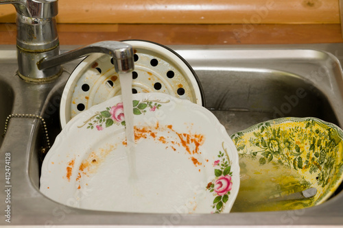 Dirty, unwashed dishes in the kitchen and sink