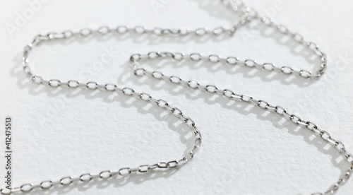 silver chain on white paper background