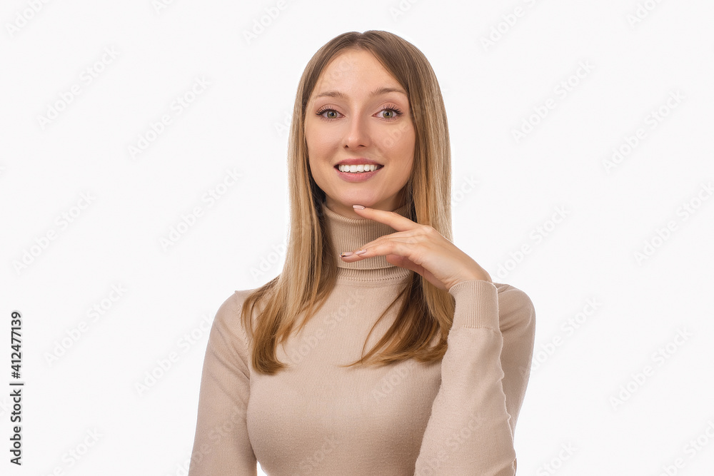 Pensive blond girl with thoughtful expression, keeps hand on chin, plans something or makes choice Pensive blond girl with thoughtful expression, keeps hand on chin, plans something or makes choice