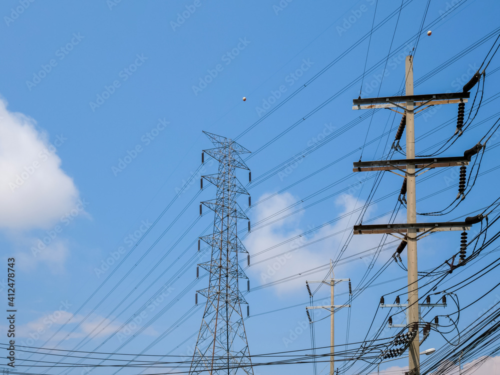 high voltage transmission towers with power line over blue sky and