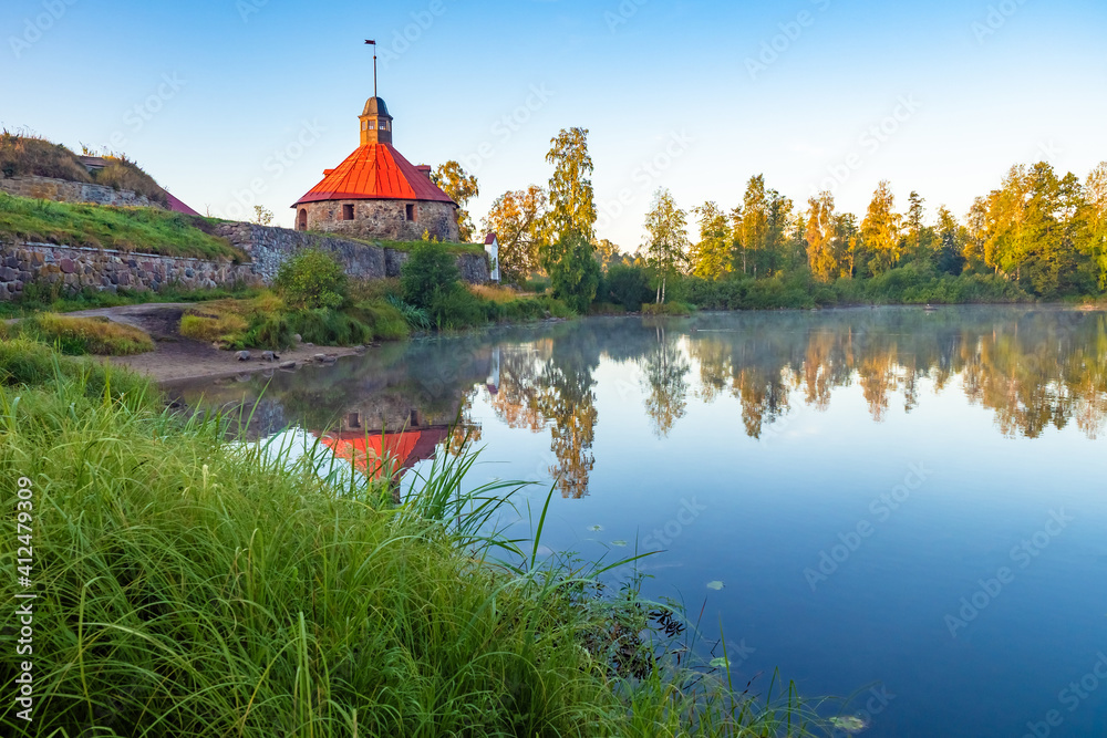 Russia. Karelia. Korella fortress near Lake Ladoga. Stone fortress stands by the lake. Stone Fort in Russian Taiga. Excursions to the sights of Karelia. Corella fortress is reflected in the water.