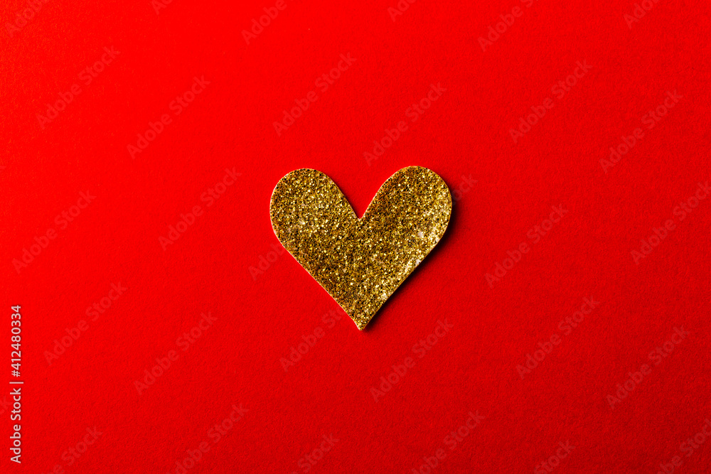 Shiny golden Heart shape sticker on red background Shiny golden Heart shape sticker on red background