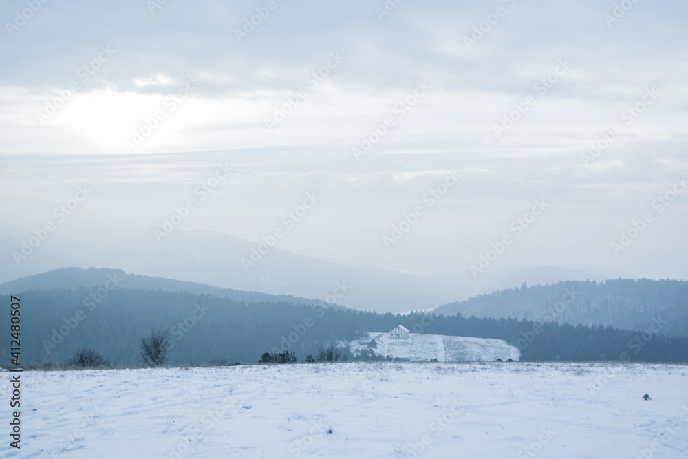 View from a hill on snowy landscape