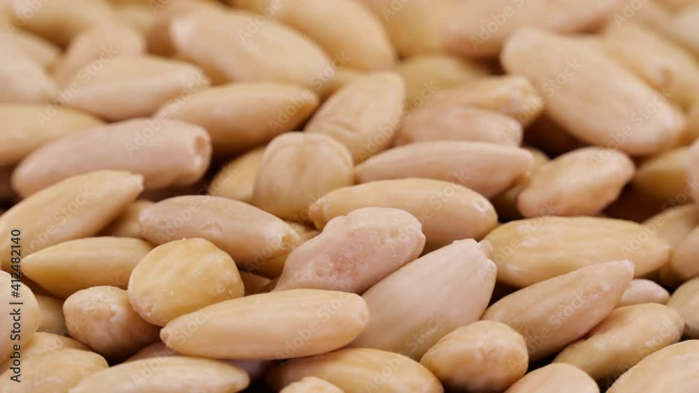 Blanched almond nuts rotating close up. Peeled almond nuts isolated. Blanched almond nuts rotating close up. Peeled almond nuts isolated.