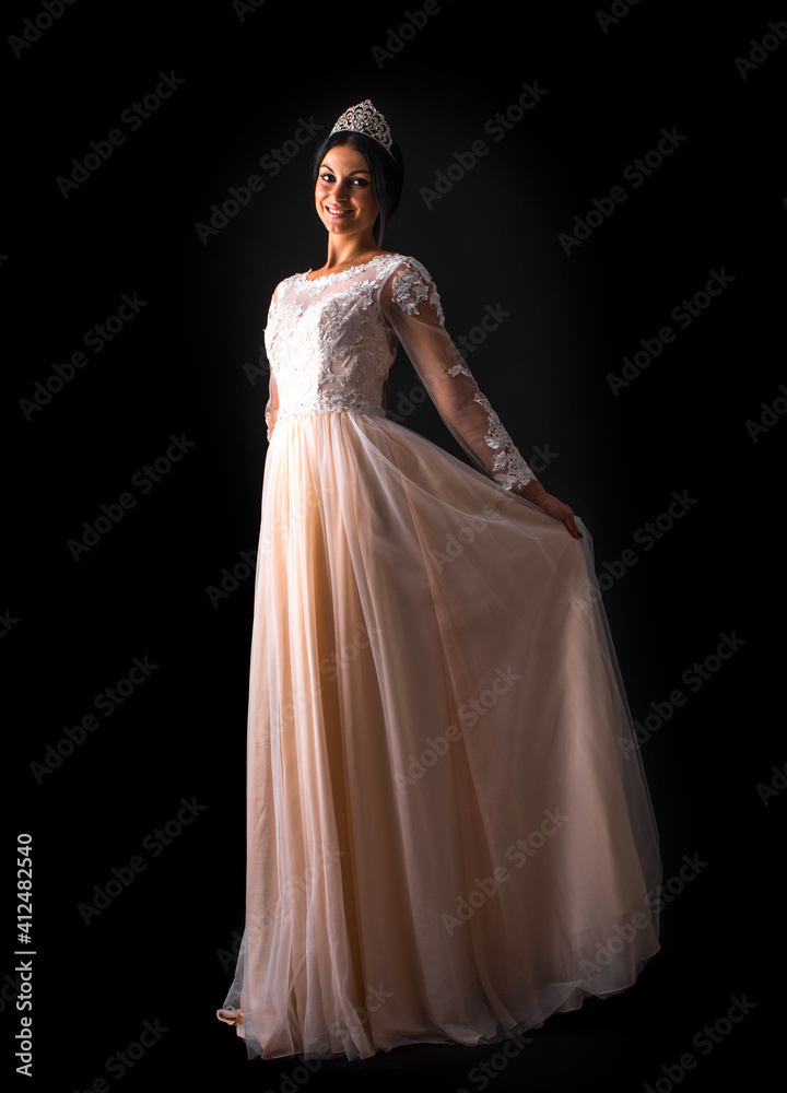 Portrait of young beautiful woman in long dress