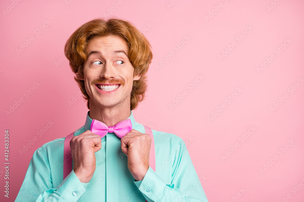 Portrait of young happy positive good mood cheerful man look copyspace fixing bow tie isolated on pastel color background Portrait of young happy positive good mood cheerful man look copyspace fixing bow tie isolated on pastel color background