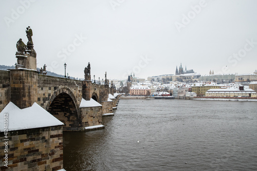 Snow on Charles bridge and Prague castle in winter