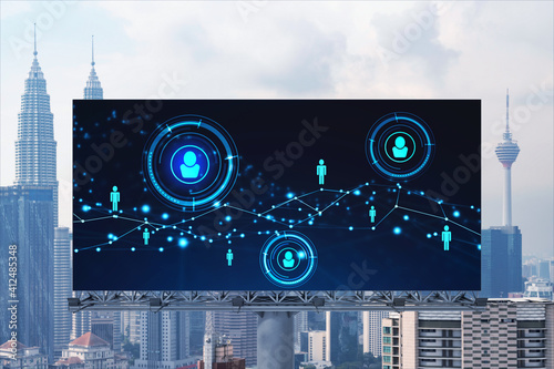 Glowing Social media icons on road billboard over panoramic city view of Kuala Lumpur, Malaysia, Asia. The concept of networking and establishing new connections between people and businesses in KL.