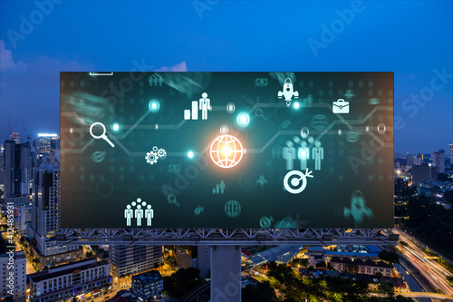 Research and technological development glowing icons on billboard. Night panoramic city view of Kuala Lumpur. Concept of innovative activities expanding new services or products in Malaysia, Asia.