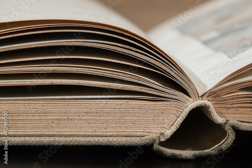  Fragment of an open book lying on the table.