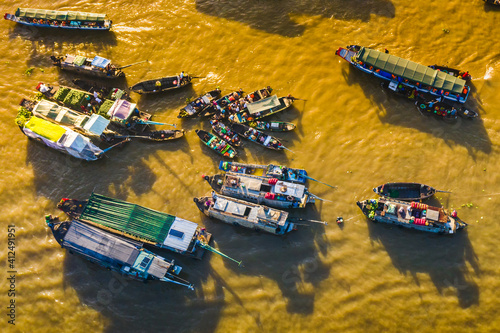 Can Tho Jan 21, 2020. Aerial view of Cai Rang floating market at sunrise, boats selling wholesale fruits and goods on Can Tho River, Mekong Delta region, South Vietnam, tourism destination
 photo