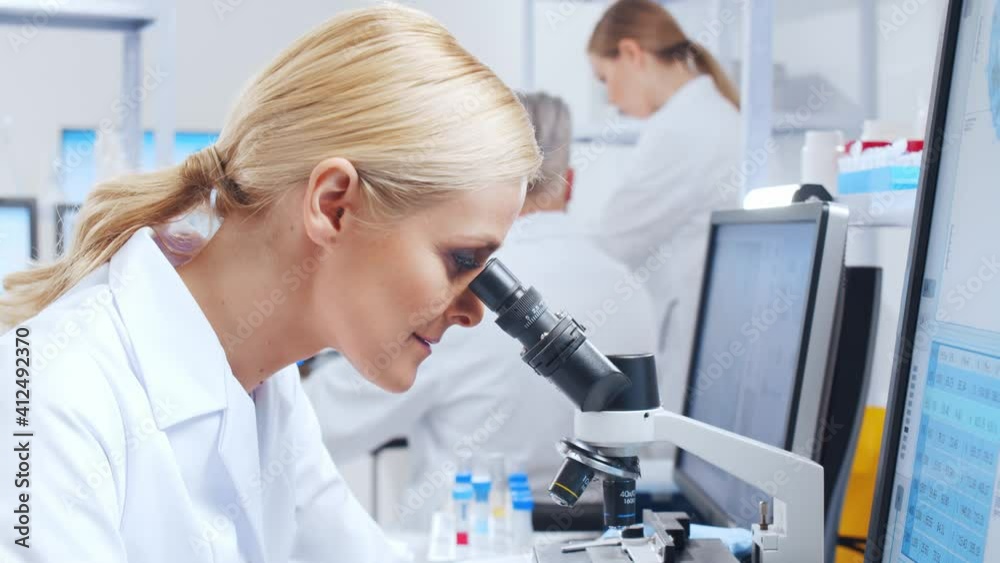 Professional team of scientists is working on a vaccine in a modern scientific research laboratory. Genetic engineer workplace. Future technology and science. Professional team of scientists is working on a vaccine in a modern scientific research laboratory. Genetic engineer workplace. Future technology and science.