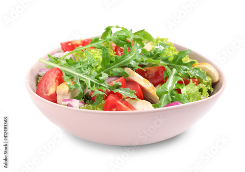 Delicious salad with chicken, arugula and tomatoes in bowl isolated on white