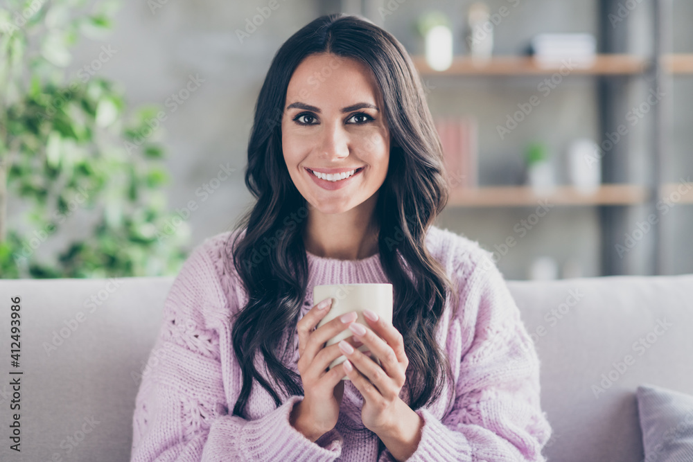 Photo of charming attractive happy lady sit couch hold hands cup of coffee indoors inside house apartment Photo of charming attractive happy lady sit couch hold hands cup of coffee indoors inside house apartment