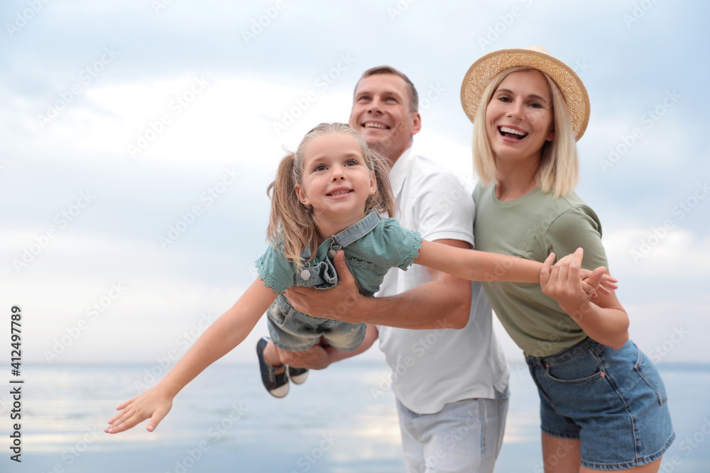 Happy family spending time together near sea on sunny summer day Happy family spending time together near sea on sunny summer day