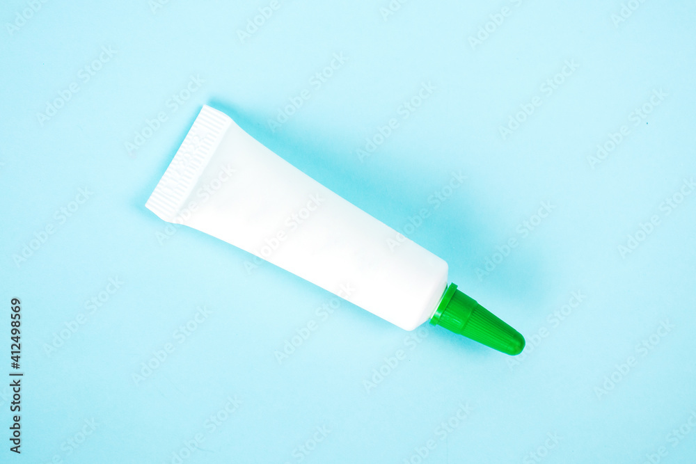 Cosmetic bottle isolated on blue background. Mock up container for design. Medical and cosmetics concept.