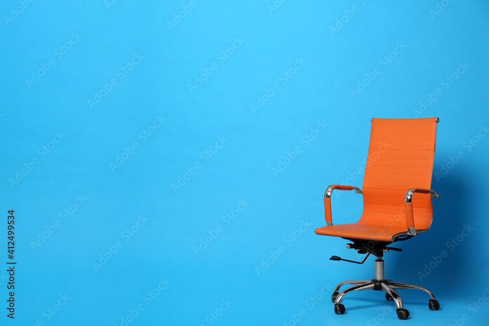 Comfortable office chair on light blue background, space for text Comfortable office chair on light blue background, space for text