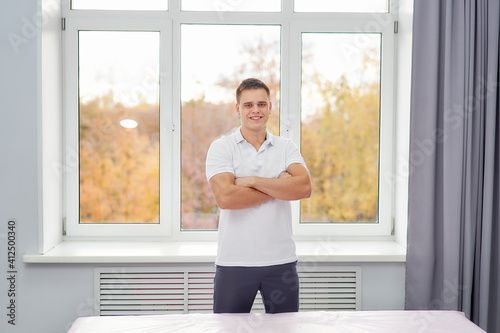 A male massage therapist stands at the massage table in the cabin with his arms crossed. Free Download A male massage therapist stands at the massage table in the cabin with his arms crossed. - GFXLoad