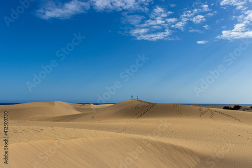 Couple walking through Gran Canaria desert dunes