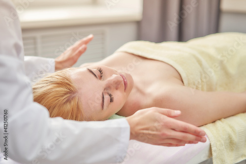 Hygienic facial massage. Relaxing procedures for a woman in a spa salon.
