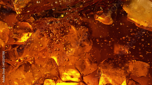 Detail of cola or alcoholic drink with ice cubes